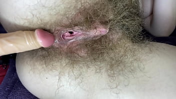 Hairy girl fucks her wet big clit pussy with di