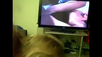 Mom gives son head while he watches porn